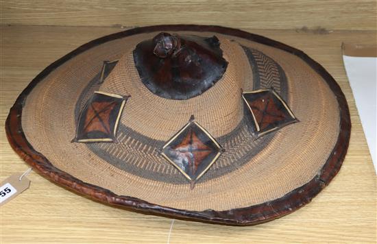 An Eastern straw and leather hat